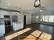 Living room view into kitchen featuring white cabinets, island, and stainless steel appliances at 309 General As Johnston St, Stanley, NC 28164