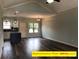 Open-concept living room with modern lighting and a view into the stylish kitchen at 309 General As Johnston St, Stanley, NC 28164