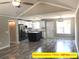 Open concept living room showcasing kitchen with stainless steel appliances and center island at 309 General As Johnston St, Stanley, NC 28164