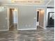 Open living room showcasing modern gray flooring and neutral wall paint at 309 General As Johnston St, Stanley, NC 28164