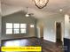 Bright living room with hardwood floors, modern ceiling fan, and multiple windows at 309 General As Johnston St, Stanley, NC 28164