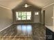 Bright living room with modern ceiling fan, and multiple windows at 309 General As Johnston St, Stanley, NC 28164