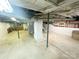 Spacious unfinished basement with exposed pipes, offering potential for customization and additional living space at 32341 Speiss Rd, Albemarle, NC 28001