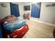 Bedroom with modern vinyl floors, featuring a race car bed and wall-mounted TV for a playful, relaxing atmosphere at 32341 Speiss Rd, Albemarle, NC 28001