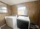 Bright laundry room featuring a large window, a washing machine, and a dryer for convenience at 32341 Speiss Rd, Albemarle, NC 28001