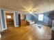 Classic blue living room featuring a large window, hardwood floors, and traditional furnishings at 32341 Speiss Rd, Albemarle, NC 28001