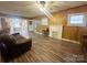 Bright living room showcasing wood-look floors, a decorative fireplace, and natural light from multiple windows at 32341 Speiss Rd, Albemarle, NC 28001