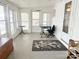 Well-lit sun room with multiple windows, ideal for a home office space, featuring white walls at 32341 Speiss Rd, Albemarle, NC 28001