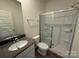 Bathroom features a shower with glass doors and a single sink vanity at 330 Knotty Wood Dr # 67, Monroe, NC 28110