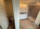 A bathroom featuring a vanity with double sinks and a walk-in shower with gray tile walls at 330 Knotty Wood Dr # 67, Monroe, NC 28110