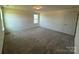 Spacious bedroom with neutral walls, plush carpeting, and a window providing natural light at 330 Knotty Wood Dr # 67, Monroe, NC 28110