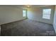 This large carpeted bedroom features natural light and is move in ready at 330 Knotty Wood Dr # 67, Monroe, NC 28110