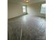 A bright bedroom with neutral walls and carpet, featuring a window and a ceiling light at 330 Knotty Wood Dr # 67, Monroe, NC 28110