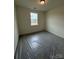 Cozy bedroom features a bright window, neutral walls, and plush carpeting at 330 Knotty Wood Dr # 67, Monroe, NC 28110