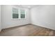 Well-lit room featuring wood-look flooring and a large window allowing natural light to fill the space at 330 Knotty Wood Dr # 67, Monroe, NC 28110