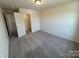 This bedroom features neutral carpeting and a conveniently placed closet for optimal storage solutions at 330 Knotty Wood Dr # 67, Monroe, NC 28110