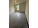 A bedroom with neutral walls and carpet, featuring a window that provides natural light to the room at 330 Knotty Wood Dr # 67, Monroe, NC 28110