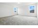 Upstairs bedroom with neutral carpet and two large windows at 330 Knotty Wood Dr # 67, Monroe, NC 28110