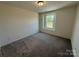 Neutral carpeted bedroom with one window allowing natural light at 330 Knotty Wood Dr # 67, Monroe, NC 28110