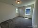 Carpeted bedroom with neutral walls and two windows at 330 Knotty Wood Dr # 67, Monroe, NC 28110