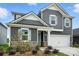 Charming two-story home with gray siding, stone accents, white trim, and an attached two-car garage at 330 Knotty Wood Dr # 67, Monroe, NC 28110