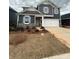 Charming two-story home featuring a manicured lawn, a two-car garage, and stone accents at 330 Knotty Wood Dr # 67, Monroe, NC 28110