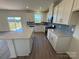 Spacious kitchen features white cabinets, stainless appliances, island, gray backsplash, and natural light at 330 Knotty Wood Dr # 67, Monroe, NC 28110