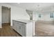 Open concept living room with an island kitchen featuring white cabinets and modern finishes at 330 Knotty Wood Dr # 67, Monroe, NC 28110