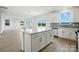 Open concept living room featuring an island kitchen with white cabinets and plenty of natural light at 330 Knotty Wood Dr # 67, Monroe, NC 28110