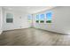 Bright, open room featuring luxury vinyl flooring and large windows with scenic outdoor views at 330 Knotty Wood Dr # 67, Monroe, NC 28110