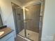 Elegant glass enclosed shower with tiled walls, tiled floors, and vanity at 330 Knotty Wood Dr # 67, Monroe, NC 28110