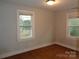 Bedroom with neutral paint, hardwood floors, and natural light from two windows at 3628 Michigan Ave, Charlotte, NC 28215