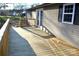 Sunlit wooden back deck featuring access to the house and views of the yard at 3640 Muskrat Se Pl, Concord, NC 28025