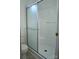 A bathroom features a shower with sliding glass doors and white tile at 3640 Muskrat Se Pl, Concord, NC 28025