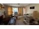 Inviting living room features a classic fireplace, patterned armchair, and natural lighting at 3694 Nc Highway 109 S Hwy, Mount Gilead, NC 27306