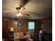 Cozy living room with wood paneling, a decorative ceiling fan, and traditional-style furniture at 3694 Nc Highway 109 S Hwy, Mount Gilead, NC 27306