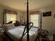 Sunlit main bedroom with a four-poster bed, and neutral decor at 3694 Nc Highway 109 S Hwy, Mount Gilead, NC 27306