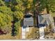 An aerial view of a home with mature trees, manicured lawn and a driveway at 3717 Marvin Rd, Charlotte, NC 28211