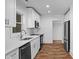 Modern kitchen featuring white cabinets, stainless steel appliances, and sleek countertops at 3717 Marvin Rd, Charlotte, NC 28211