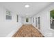Bright sunroom boasts hardwood floors, a lot of windows, and glass pane doors to a backyard at 3717 Marvin Rd, Charlotte, NC 28211