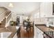 Open-concept living room and kitchen boasts wood floors and plenty of natural light at 412 Frazier Ave, Charlotte, NC 28216