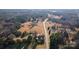 Aerial view of the property showing the home's placement within its wooded surroundings at 445 Cannon Farm Rd, China Grove, NC 28023