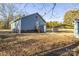 Backyard view showing the exterior of the home with a carport and storage shed at 445 Cannon Farm Rd, China Grove, NC 28023