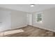 Bedroom featuring durable floors, neutral paint, and large window at 445 Cannon Farm Rd, China Grove, NC 28023