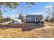 Exterior view of the house showing the detached carport in the expansive yard at 445 Cannon Farm Rd, China Grove, NC 28023