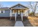 Inviting front entrance with a covered porch, white railings, and a concrete walkway at 445 Cannon Farm Rd, China Grove, NC 28023