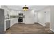 Kitchen featuring stainless appliances, white cabinetry, and light hardwood flooring at 445 Cannon Farm Rd, China Grove, NC 28023
