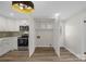 Updated kitchen with stainless steel appliances, white cabinets, and a spacious pantry at 445 Cannon Farm Rd, China Grove, NC 28023