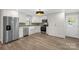 Modern kitchen with stainless steel appliances, white cabinets, and hardwood floors at 445 Cannon Farm Rd, China Grove, NC 28023