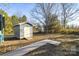 Outdoor storage shed provides secure space for tools and equipment and easy access via concrete pathway at 445 Cannon Farm Rd, China Grove, NC 28023